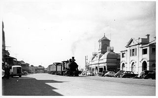 loco SAR T class on passenger train in street alongside station building - Ellen Street - Port Pirie